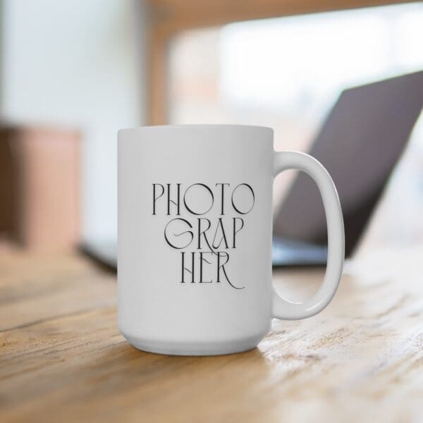 White ceramic mug with handwritten word “PHOTOGRAPHER”